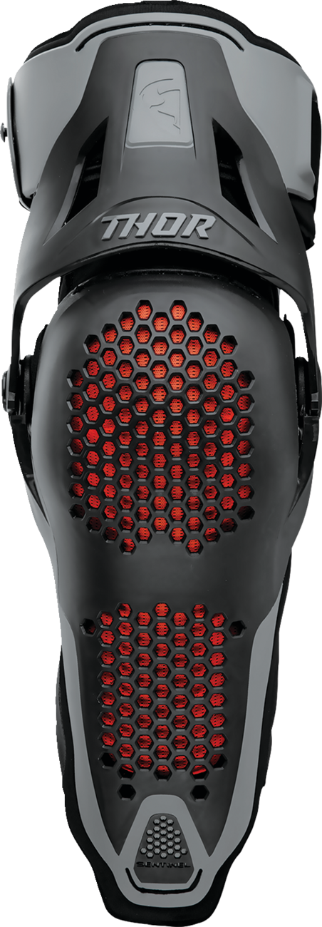 Black THOR Sentinel Knee Guards in size S/M, protective gear for motocross or outdoor sports, featuring durable padding and secure straps.